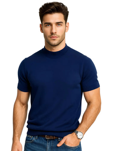 Man wearing a blue mock neck shirt and jeans on a white background